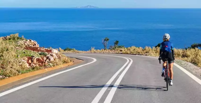 Woman cyclist enjoys cycling in Greece with a rented bike 